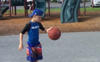 boy bouncing basketball