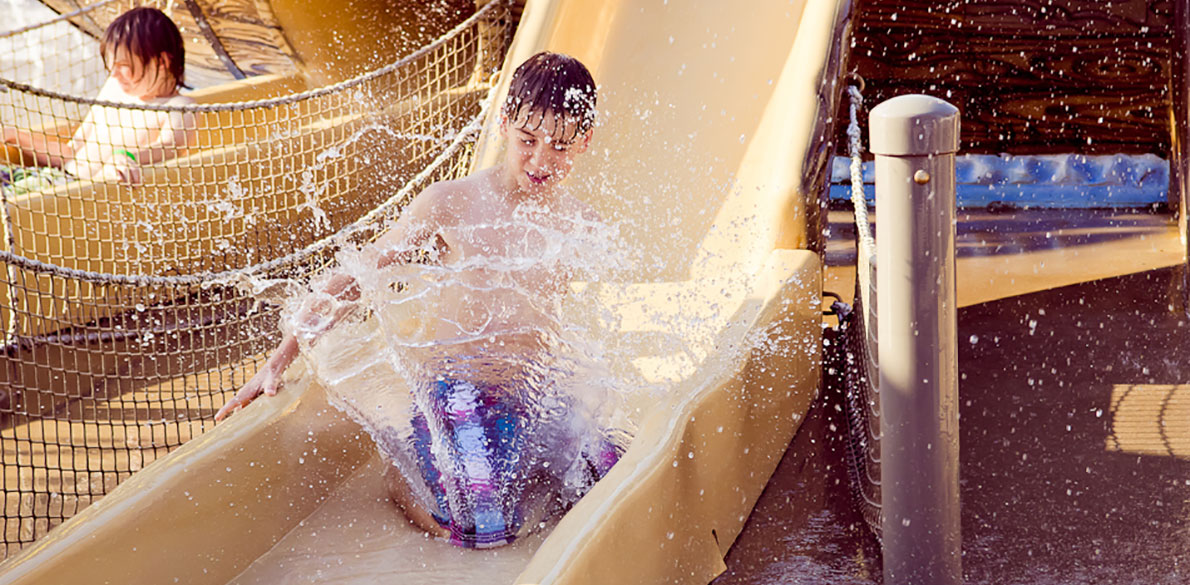Kid splashing on slide